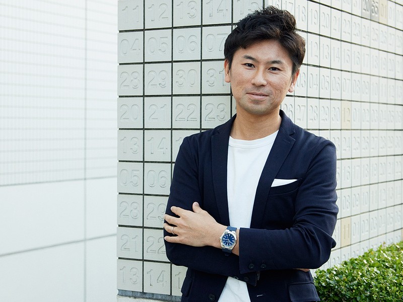 ユニフォームでもあると語るネイビージャケットの装いに、ブルー文字盤の高級ドレスポ時計がよく似合っています。