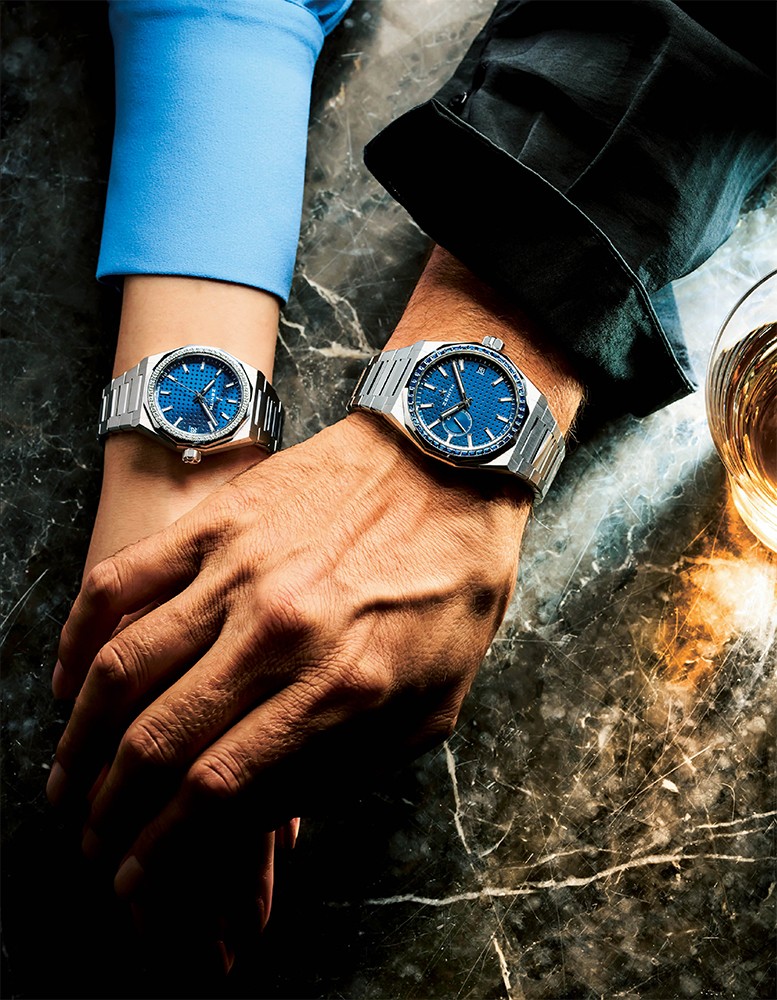 ▲ 輝きを共有できる美しきペアウォッチ ベゼルに貴石をセットしたヴァージョン。メンズサイズはサファイア、ユニセックスサイズはホワイトダイヤを採用。ラグスポ時計の先駆的存在ですが、貴石入りならタフになりすぎないので女性でも付けやすく、ペアで楽しむには最適です。ラグスポ時計は服装不問ゆえ、ペア付けの際に服のテイストを揃える必要はなし。またクイックストラップチェンジ機構で付属のラバーストラップに簡単に変えられるのも、うれしいところ。男性●『デファイ スカイライン サファイア』自動巻き、サファイヤ×SSケース(41㎜)×ブレスレット(ラバーストラップが付属)。10気圧防水。346万5000円/ゼニス 女性●『デファイ スカイライン 36』自動巻き、ダイヤモンド×SSケース(36㎜)×ブレスレット(ラバーストラップが付属)。10気圧防水。152万9000円/ゼニス、男女ともシャツはスタイリスト私物