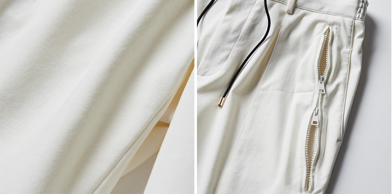 大きくあしらわれた八の字形のジップポケットは上下から開く仕様が珍しい。こなし方次第で装いのアクセントになりますよ。